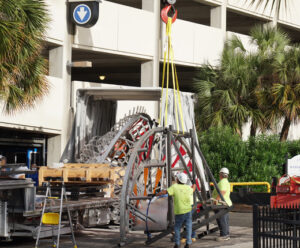 Emergence sculpture being lifted by crane